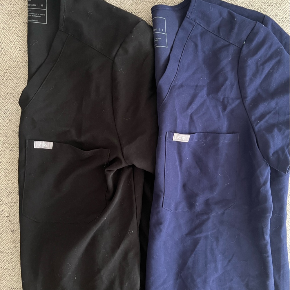 TWO FIG SCRUB SHIRTS ONE SIZE SMALL AND ONE SIZE MEDIUM (SOLD AS A SET)